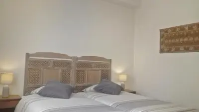 a bedroom with a bed with two pillows on it at Bombarda House & Home in Porto