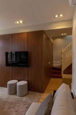 a living room with a couch and a tv on a wall at ORM - Bolhao Apartments in Porto