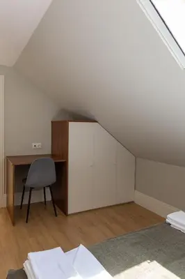 a bedroom with a desk and a chair in a attic at ORM - Bolhao Apartments in Porto