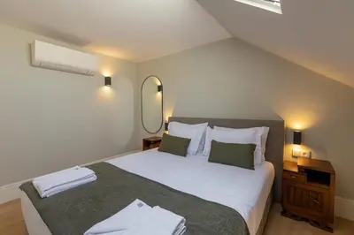a bedroom with a large bed and a mirror at ORM - Bolhao Apartments in Porto