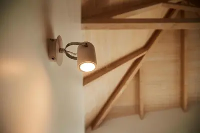 a light on a wall next to a staircase at Pause Apartments in Porto
