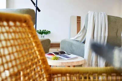 a living room with a chair and a coffee table at Pause Apartments in Porto