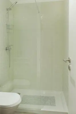 a bathroom with a glass shower and a toilet at Lovely Mezzanine in Porto with FREE PARKING in Porto