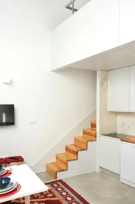 a staircase in a house with white walls and wooden floors at Lovely Mezzanine in Porto with FREE PARKING in Porto