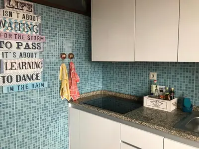 a kitchen with a sink and a sign on the wall at A Casa das Margaridas in Porto