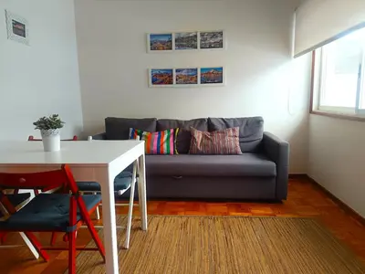 a living room with a couch and a table at Combatentes Apartment in Porto