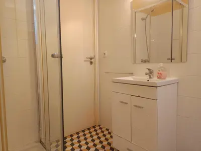 a bathroom with a shower and a sink and a mirror at Combatentes Apartment in Porto