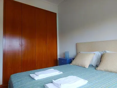 a bedroom with a bed with two towels on it at Combatentes Apartment in Porto