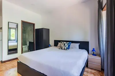 a bedroom with a large bed and a mirror at Riverside City Centre Apartments in Porto