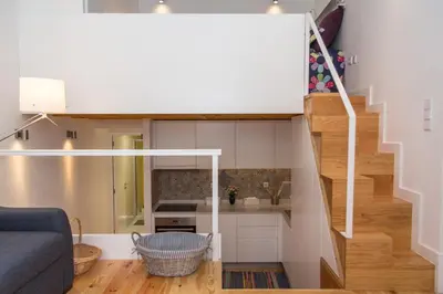 a living room with a staircase in a tiny house at Porto City Center 2 in Porto