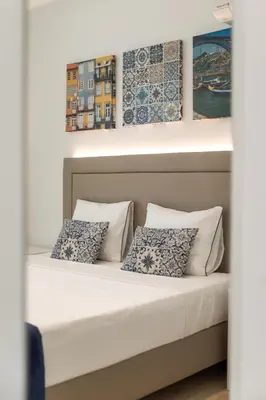 a bed in a room with two pillows at BRA.com Apartments Oporto Campanhã in Porto