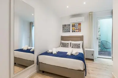 a bedroom with two beds and a mirror at BRA.com Apartments Oporto Campanhã in Porto