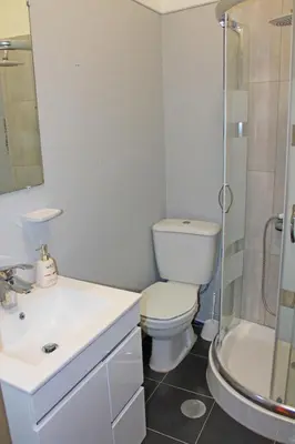 a bathroom with a toilet and a sink and a shower at Trindade Oporto Apartments Group in Porto