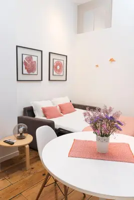 a living room with a television and a wooden floor at Santo da Casa / Sc apartments in Porto