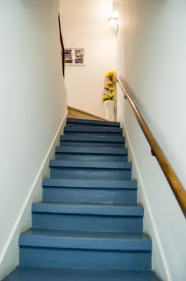 a stairway with blue stairs in a building at KOKAS Apartments in Porto