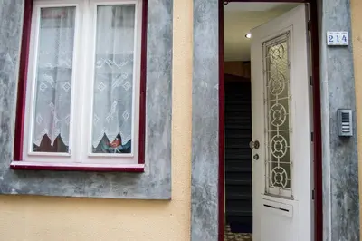 a house with a window and a white door at KOKAS Apartments in Porto