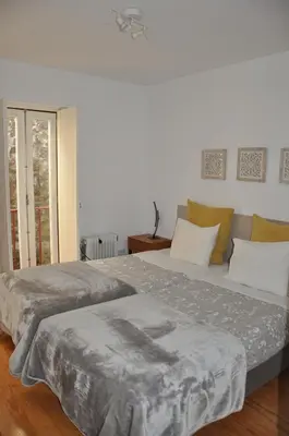 a bedroom with two beds and a window at KOKAS Apartments in Porto