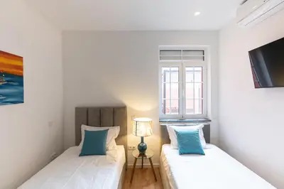 a living room with a stone wall and a couch and a table at Best House Center - with Garage in Porto