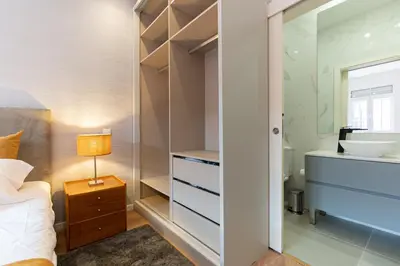 a bedroom with a bed and a closet at Best House Center - with Garage in Porto