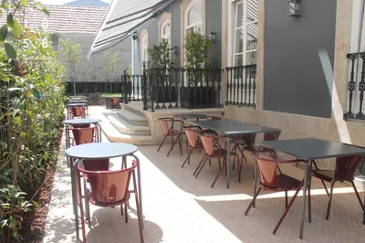 a row of tables and chairs on a patio at Oporto Serviced Apartments - Alvares Cabral in Porto