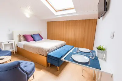 a bedroom with a bed and a table and chairs at Porto 271 Mouzinho Apartamentos in Porto