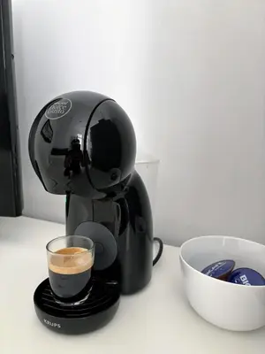 a coffee maker sitting on a counter with a cup of coffee at Covelo Apartment in Porto