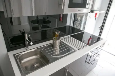 a kitchen with a sink and a counter top at Covelo Apartment in Porto