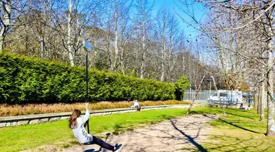 a girl on a swing in a park at Covelo Apartment in Porto