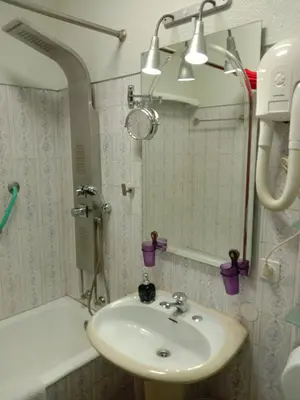 a bathroom with a sink and a shower and a mirror at Faria Guimares Porto Centro in Porto