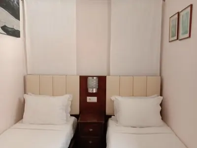 two beds in a small room with white walls at Faria Guimares Porto Centro in Porto