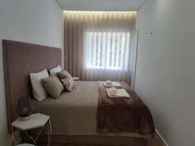 a bedroom with a large bed with a window at Suite na baixa do Porto in Porto