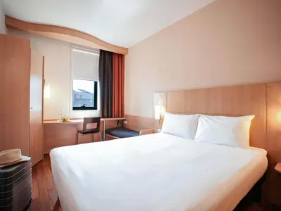 a white bathroom with a sink and a shower at ibis Porto Centro São Bento in Porto