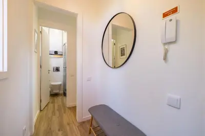 a mirror on a wall with a chair in a room at D&S - Loureiro 67 in Porto