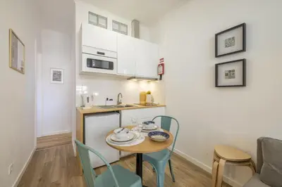 a small kitchen and dining room with a table and chairs at D&S - Loureiro 67 in Porto