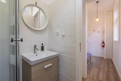 a bathroom with a sink and a mirror at D&S - Loureiro 67 in Porto