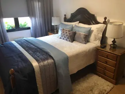 a bedroom with a large bed and a window at Alojamento Requinte in Porto