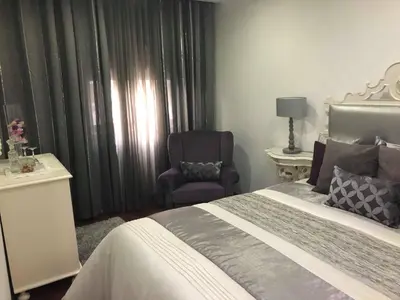 a hotel room with a bed and a chair at Alojamento Requinte in Porto