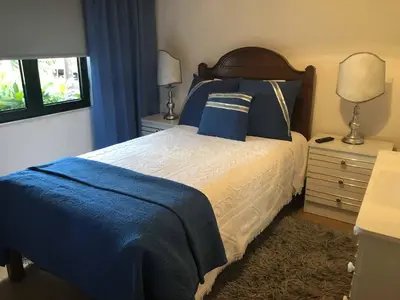 a bedroom with a bed with blue sheets and blue pillows at Alojamento Requinte in Porto