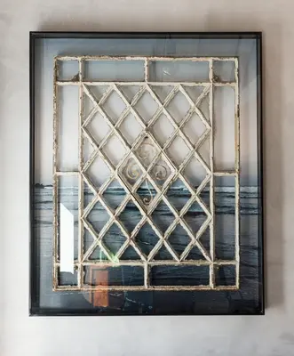 a framed picture of a window with a lattice pattern at Gold & Grey Loft Almada in Porto
