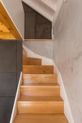 a staircase in a house with wooden floors at Gold & Grey Loft Almada in Porto