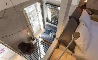 an overhead view of a room with a bed and a window at Gold & Grey Loft Almada in Porto