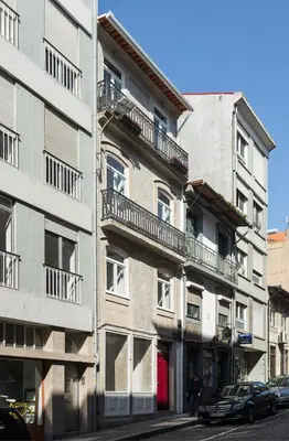 an apartment building with balconies on a city street at Gold & Grey Loft Almada in Porto