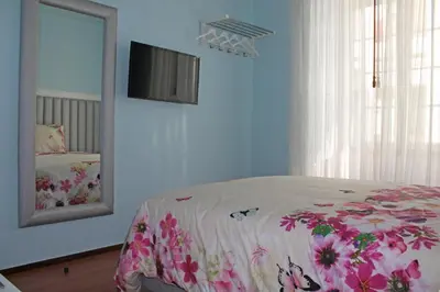 a bedroom with a bed with a mirror and a bed sidx sidx sidx at Grande Oceano Guest House in Porto