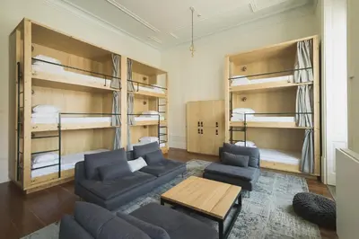 a living room with two couches and bunk beds at The Passenger Hostel in Porto