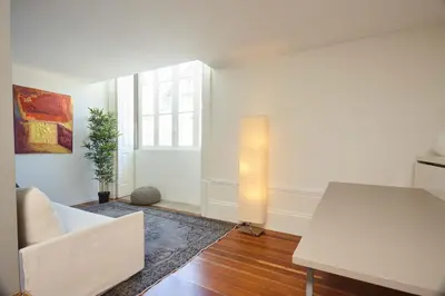 a living room with a couch and a table at The Passenger Hostel in Porto