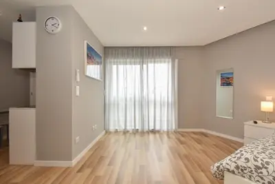 a bedroom with a bed and a clock on the wall at Oporto Bernardes Studios - Heroísmo in Porto