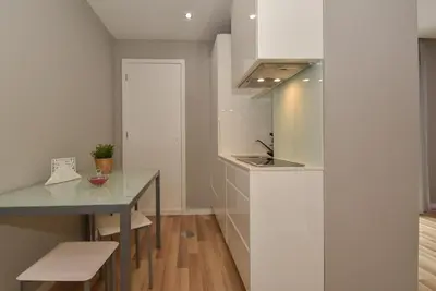 a kitchen with a counter and a table and a sink at Oporto Bernardes Studios - Heroísmo in Porto