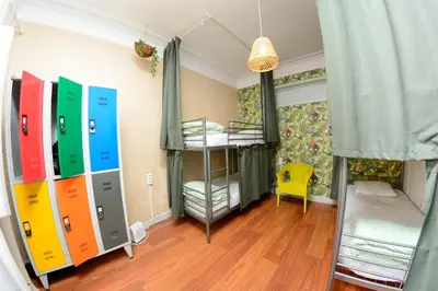 a room with two bunk beds and a room with a window at Travel & Live Hostel in Porto