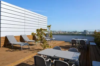 a balcony with tables and chairs on a building at Serviced Apartments Boavista Palace in Porto