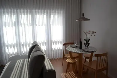 a living room with a table and a couch and a dining room at RockInn Porto in Vila Nova de Gaia